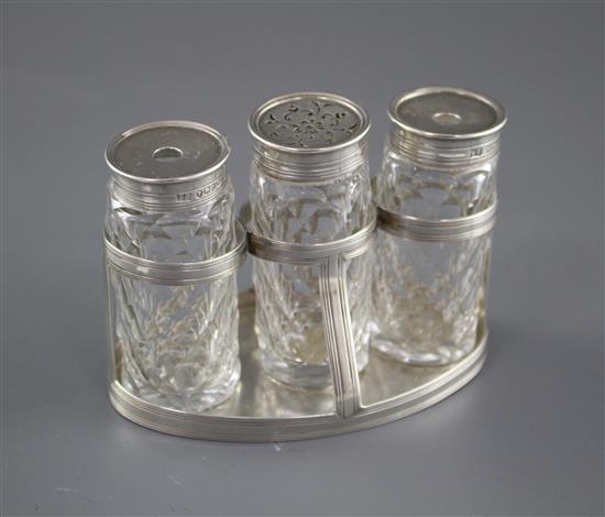 A George III silver oval ink bottle stand, London, 1799 (no makers mark), with three later Victorian silver monted glass bottles